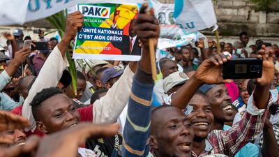 Supporters of opposition presidential candidate Guy Brice Parfait Kolelas cheer during their party’s last rally of the presidential campaign. AP