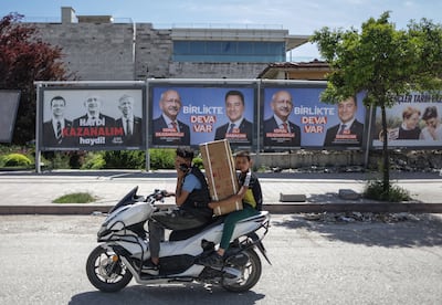 People ride past pictures of the Turkish presidential candidate Kemal Kilicdaroglu, leader of the opposition Republican People's Party (CHP). EPA