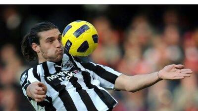 Andy Carroll, Newcastle United’s rugged centre-forward, controls the ball against Arsenal.