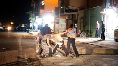 Iraqi security forces remove a suicide vest from a boy in Kirkuk, Iraq. Ako Rasheed / Reuters