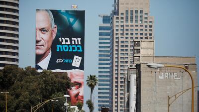A Blue and White party election campaign banner depicting its leader, Israeli Defence Minister Benny Gantz, alongside Israeli Prime Minister Benjamin Netanyahu is seen in Tel Aviv ahead of Israel's election on March 23, 2021. Reuters