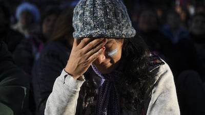 A fans of Argentina gestures in dejection as she watches the World Cup match between Argentina and Croatia on a giant screen at San Martin square in Buenos Aires. Eitan Abramovich / AFP