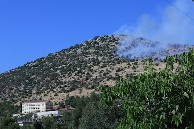 Smoke rises from a forested area near Kfarshouba. AFP