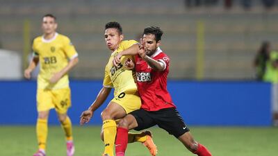 Al Ahli, in red, recovered from their early struggles in the Arabian Gulf League to defeat Al Wasl, in yellow, 5-1 at Zabeel Stadium in Dubai on September 26, 2014. Courtesy Al Ittihad / Ashraf Umrah