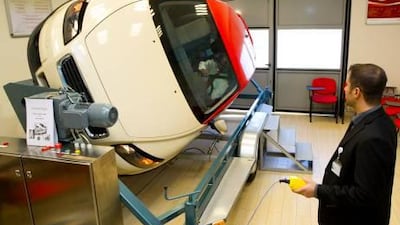 Jalal Prasanna Wijeseker tests the simulator operated by Fakher Alsalam, a driver trainer, in the fleet drivers affairs department of the Dubai Taxi Corporation.