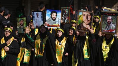 Lebanese women affliated to Hizbollah march holding pictures of their relatives killed in Syria as they mark Ashura in a southern suburb of Beirut on October 1, 2017.