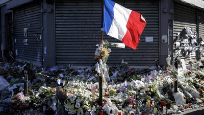 A French flag flies outside The Petit Cambodge, one of the targets of terrorist attacks in Paris. (Laurent Cipriani / AP)