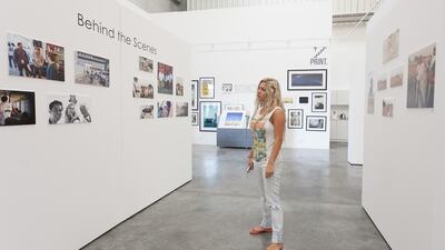 Ebla Maleh, of Gulf Photo Plus, inspects the exhibition of images from the Fujairah photo walk, which were all taken on HTC smartphones. Clint McLean for The National