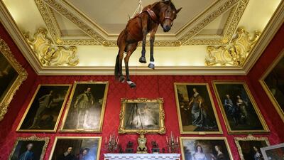 Italian artist Maurizio Cattelan’s work ‘Novecento’, the body of a thoroughbred racehorse preserved by taxidermy and suspended from the ceiling of Blenheim Palace in Woodstock, England. Getty Images