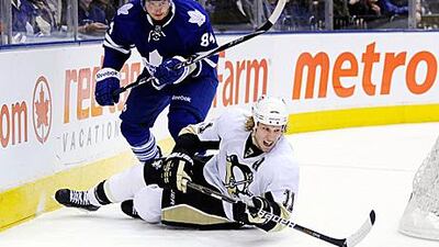 Toronto Maple Leafs's Mikhail Grabovski, who scored the overtime winner, battles for the puck with Pittsburgh Penguins's Jordan Staal.