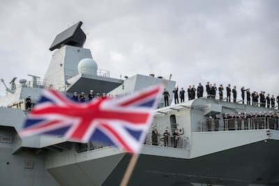 People cheer as 'HMS Queen Elizabeth' arrives in Portsmouth, England. Getty Images