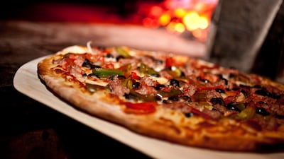 A coal-fired pie at John’s Pizzeria of Times Square, housed inside a former church on West 44th Street. Photo: John's Pizzeria of Times Square