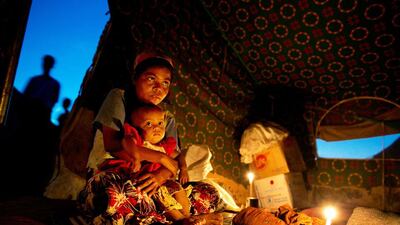 Aaisha sits in her tent with her 11 month old baby Bibi Aisha at a refugee tented camp for Rohingya IDP's November 23, 2012 on the outskirts of Sittwe, Myanmar. Paula Bronstein / Getty Images