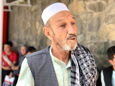 Khan Mohammad, 70, waits outside the emergency hospital with his brother for news on his nephew, who is in a coma due to injuries sustained in an ISIS attack on a Hazara Shia wedding in Kabul on Saturday night. Hikmat Noori for The National