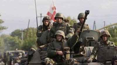 Georgian soldiers sit on a tank moving near the town of Tskhinvali, some 100km (62 miles) from Tbilisi. Georgia has withdrawn its forces from breakaway South Ossetia, where they had been fighting Russian troops for control, the Georgian interior ministry said today.