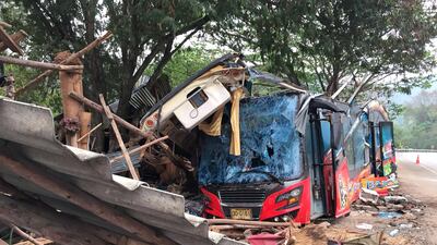 The wreckage of a tourist bus sits beside devastated roadside stalls at a crash site after an accident on a highway in Nakhon Ratchasima province, Thailand, on March 22, 2018. EPA