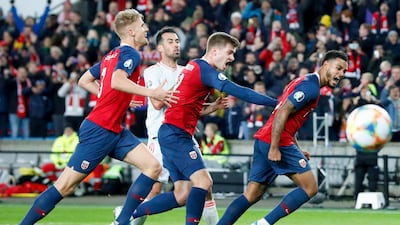 Norway's Kristoffer Ajer, Alexander Soerloth Joshua King celebrate after 1-1 during the UEFA Euro 2020 qualifying Group F soccer match between Norway and Spain at Ullevaal Stadium in Oslo, Norway. AP