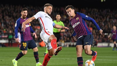Barcelona's Philippe Coutinho is challenged by Sevilla's Carrico. Getty Images