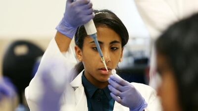 Maryam Al Hashimi from Al Yasmina School in Abu Dhabi learns how to test food for bacterial contamination during the Genes in Space workshop in the lab of Emirates College for Advanced Education in Abu Dhabi. Pawan Singh / The National