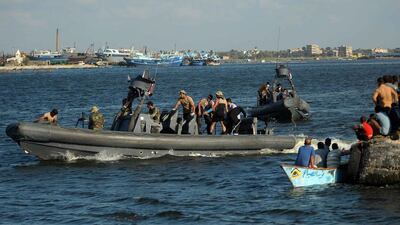 Egyptian military boats carrying bodies recovered from the sinking of a migrant boat arrive at the port city of Rosetta, some 250km north of Cairo, on September 22, 2016. Tarek Alfaramawy / EPA
