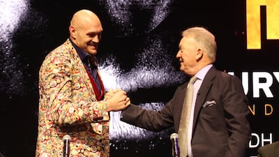 Tyson Fury, left, shakes hands with boxing promoter Frank Warren. Getty