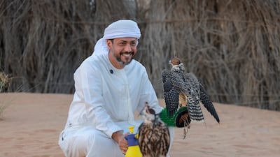 Ammar bin Humaid Al Marri quenches the thirst of his falcon, Shaman