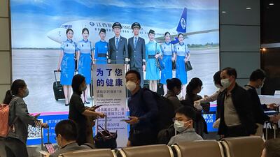 Passengers prepare to board a flight at an airport in China's Jiangxi province. AP