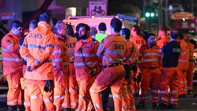 Emergency services workers gather at the scene after the shooting. AFP