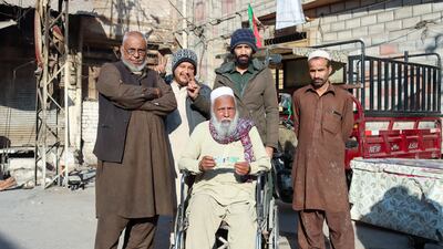 A disabled man being taken to cast his vote in Peshawar, Pakistan. Musa Kamal for The National