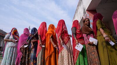 Women wait cast their votes in a state election in Rajasthan in 2023. AP