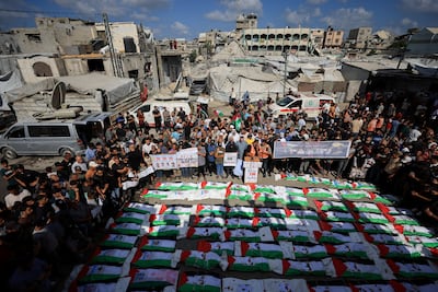 Palestinians attend a mass funeral for people killed in an Israeli strike in 2023 after their bodies were recovered. Reuters