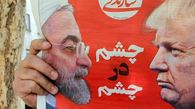 An Iranian man reads a newspaper with a pictures of Iranian president Hassan Rouhani and US President Donald Trump on its front page in Tehran, Iran, 9 April 2019. EPA
