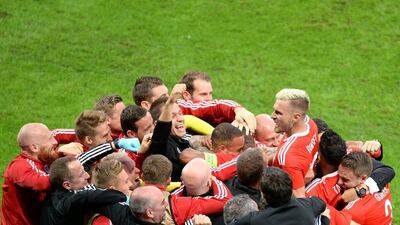 Wales players celebrate after Ashley Williams scores the equalising goal. Denis Charlet / AFP