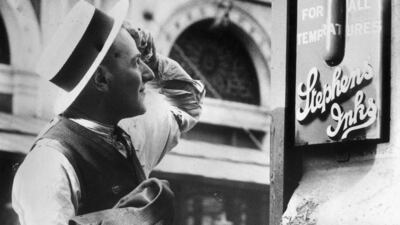 A passer by mops his brow as he reads a thermometer in Smithfield Market, London, in 1938.