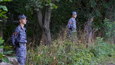 Servicemen guard the Porokhov cemetery. AP