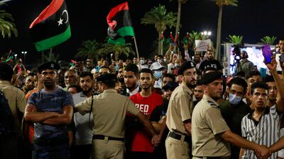 Demonstrators protest in Tripoli, Libya, last year, in opposition to parliament passing a vote of no-confidence in the transitional government. Deep divisions and the introduction of disputed candidates have led to election delays in the country. AP