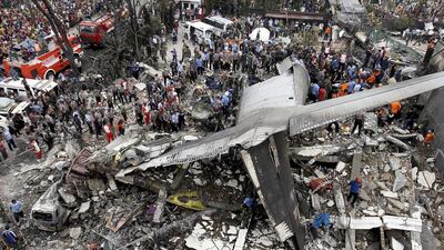Security forces and rescue teams examine the wreckage of an Indonesian military C-130 Hercules transport plane after it crashed into a residential area in the North Sumatra city of Medan, Indonesia, June 30, 2015. More than 100 people are believed to have been killed. Roni Bintang/Reuters