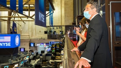 New York mayor Andrew Cuomo looks over the floor of the New York Stock Exchange on Tuesday as he rings the opening bell. New York Stock Exchange via AP