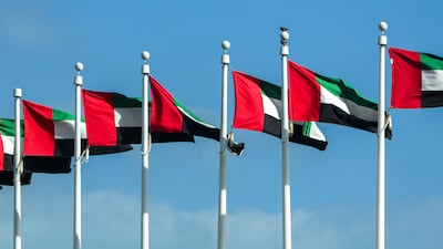 UAE flags raised above Emirates Palace in Abu Dhabi. Victor Besa / The National