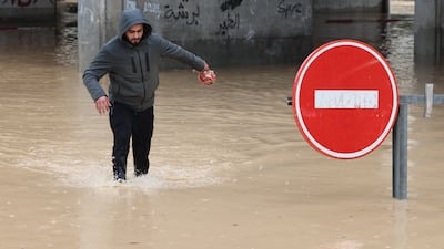 A pedestrian navigates flooded roads in Tunis. Flooding across Tunisia left at least four people dead on Tuesday. EPA