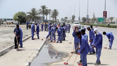 Municipality workers cleaning the road near the corniche after the recent flood in Fujairah.