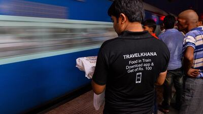 An employee of TravelKhana waits at the platform to deliver food to passenger at the Mathura Junction in Mathura. Passengers on India's vast railway network have long complained of the terrible food on offer to sustain them on long journeys, but now all that is changing thanks to a slew of new services bringing fast food to your seat. Chandan Khanna/AFP