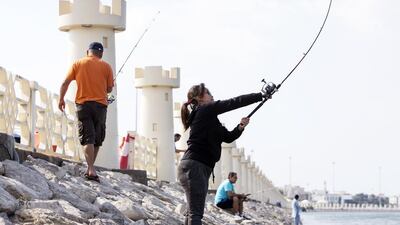 Many people, such as Melanie Medrano from the Philippines, went fishing on Sunday. Christopher Pike / The National