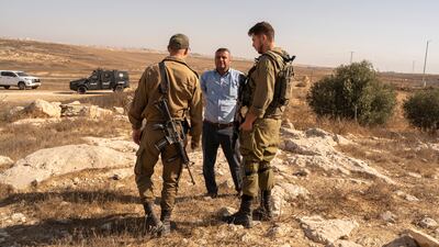 Israeli soldiers confront a Palestinian man in the occupied West Bank. The UN has recorded more than 1,000 attacks by Israeli settlers across the territory this year. David Lombeida for The National