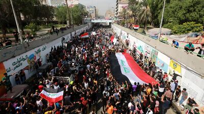 Iraqi protesters carry national flags as they protest in Baghdad, Iraq. EPA