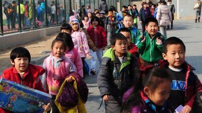 School children leave their elementary school at the end of classes in Beijing. Mark Ralston / AFP