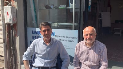 Nasip Kaplan, left, and Cevat Aydogan own shops on opposite sides of the road in Istanbul's Tarlabasi neighbourhood and have different views on who should be Turkey's next president. Jamie Prentis / The National