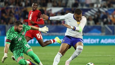 Kylian Mbappe on the ball as Canada goalkeeper Maxime Crepeau attempts to close him down. AFP