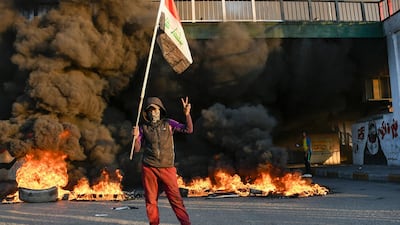 Iraqi Anti-government demonstrators block a road with debris and burning tires in the southern Iraqi city of Nasiriyah. AFP