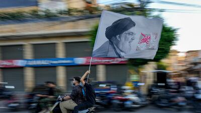 Hezbollah supporters carry a flag depicting Hassan Nasrallah in Beirut. His killing could rally Lebanese people behind the group. AP
